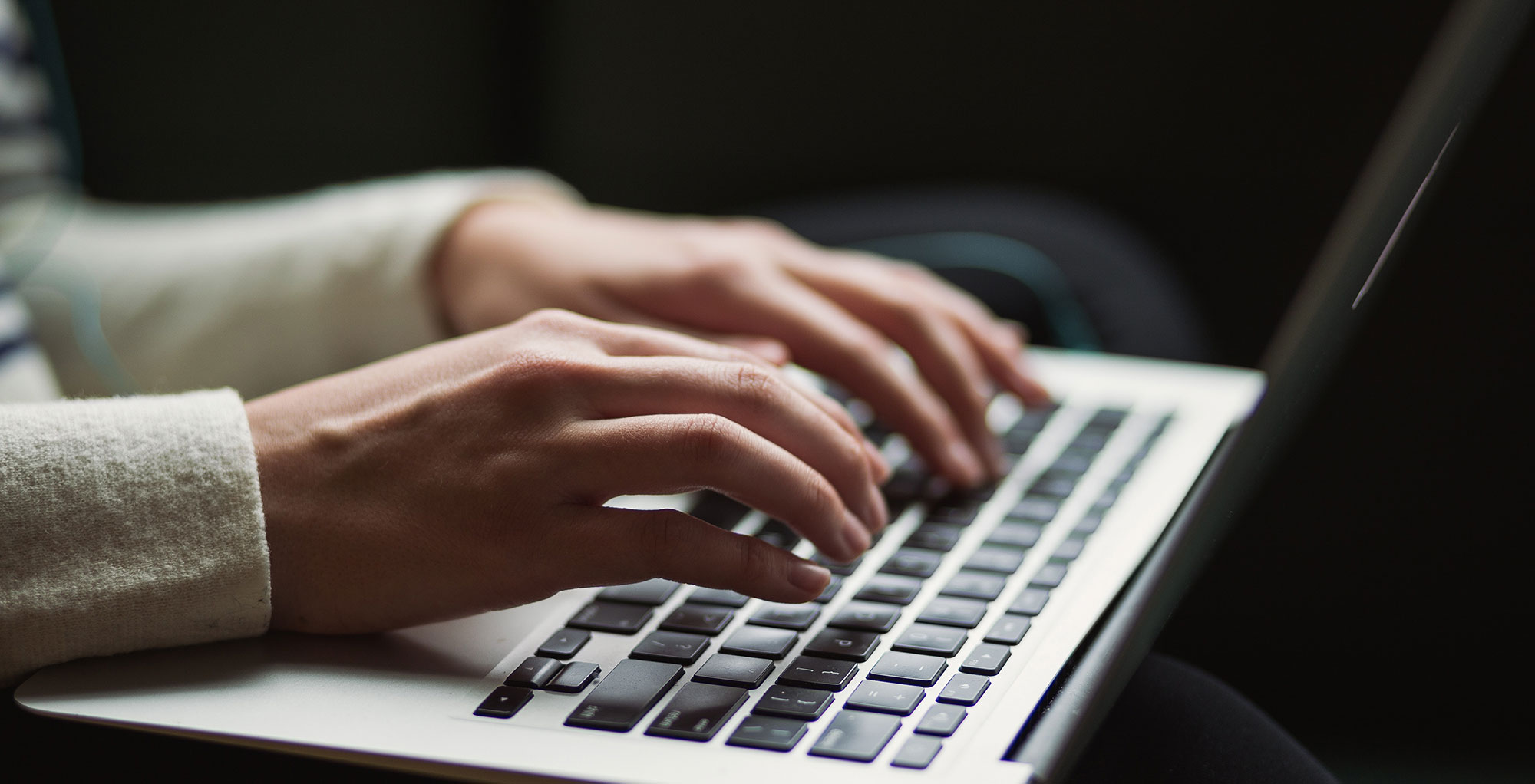 intake form - person typing on laptop